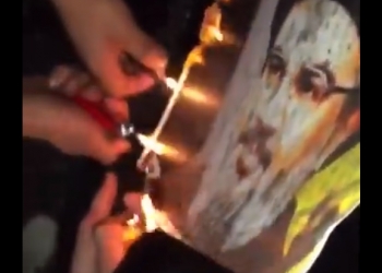 שורפים את תמונת חסן נסראללה בביירות, לבנון מתפוררת, לאחר יום הקרב אמש: